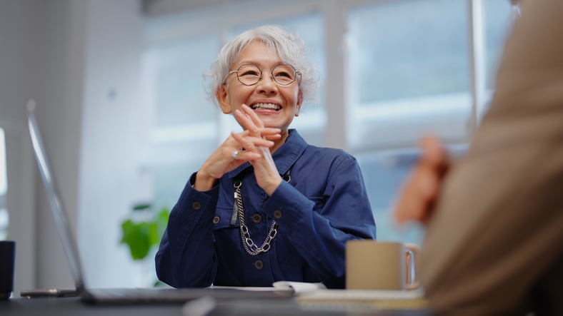 Woman smiling at desk